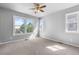 Bright and airy bedroom with large windows, neutral walls, and ceiling fan at 10778 Dayton Way, Commerce City, CO 80640