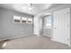 Bright bedroom featuring neutral walls, carpet, large windows, and a ceiling fan at 10778 Dayton Way, Commerce City, CO 80640