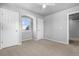 Bright bedroom featuring neutral walls, carpet, large windows, and a ceiling fan at 10778 Dayton Way, Commerce City, CO 80640