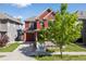 Charming two-story home with a covered front porch and a well-manicured lawn at 10778 Dayton Way, Commerce City, CO 80640
