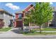 Inviting home with a front porch, garage, and lush landscaping at 10778 Dayton Way, Commerce City, CO 80640