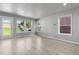 Bright living room featuring windows, door to the outside, hardwood floors, and neutral paint at 10778 Dayton Way, Commerce City, CO 80640