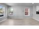 Bright and airy living room filled with natural light, hardwood floors, and neutral paint colors at 10778 Dayton Way, Commerce City, CO 80640