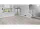 View of living room showcasing the staircase, hardwood floors, and neutral paint, creating a warm atmosphere at 10778 Dayton Way, Commerce City, CO 80640