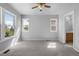 Bright main bedroom with dual windows, carpet, and a view to the en-suite bathroom at 10778 Dayton Way, Commerce City, CO 80640