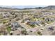 A picturesque aerial shot of a residential community surrounded by mountains and open land at 5986 Dunraven Ct, Golden, CO 80403
