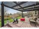 Backyard patio with modern seating area, covered by decorative pergola at 5986 Dunraven Ct, Golden, CO 80403