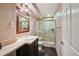 Modern bathroom with decorative vanity mirror and stand up shower enclosure at 5986 Dunraven Ct, Golden, CO 80403