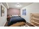 Relaxing bedroom with a comfortable bed, soft lighting, and a wall-mounted art piece at 5986 Dunraven Ct, Golden, CO 80403