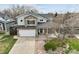 Charming two-story home featuring a stone facade, covered porch, and well-maintained front yard at 5986 Dunraven Ct, Golden, CO 80403