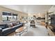 Bright living room featuring a large window with backyard views and comfortable seating at 5986 Dunraven Ct, Golden, CO 80403