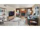 Inviting living room featuring a stone fireplace, comfortable seating, and natural light, perfect for relaxation and entertaining at 5986 Dunraven Ct, Golden, CO 80403