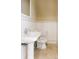 Elegant powder room with pedestal sink, white subway tile, and marble floors at 8100 E Union Ave # 2201, Denver, CO 80237
