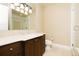 Bathroom with marble countertops, dark wood cabinets, and a glass-enclosed shower at 8100 E Union Ave # 2201, Denver, CO 80237