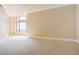 Bright bedroom with a large window and light-colored walls and carpet at 8100 E Union Ave # 2201, Denver, CO 80237