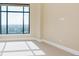 Bedroom with large window allowing for natural light and views with neutral carpet flooring at 8100 E Union Ave # 2201, Denver, CO 80237
