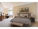 Cozy bedroom features large windows, accent furniture, art and comfortable bedding at 8100 E Union Ave # 2201, Denver, CO 80237