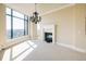 Sunlit dining area features a modern fireplace and a classic chandelier with beautiful city views from expansive windows at 8100 E Union Ave # 2201, Denver, CO 80237
