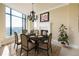 Formal dining room boasts cityscape views from large windows, enhanced by a fireplace, chandelier, and room for six at 8100 E Union Ave # 2201, Denver, CO 80237