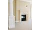 Close up on a fireplace with detailed mantel, contrasting trim, and a view of the carpeted living room at 8100 E Union Ave # 2201, Denver, CO 80237