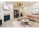 Traditional living room with fireplace, large area rug, dark bookcase, couch and accent chairs at 8100 E Union Ave # 2201, Denver, CO 80237