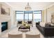 Elegant living room with a cozy fireplace, refined decor, and expansive windows offering panoramic city views at 8100 E Union Ave # 2201, Denver, CO 80237