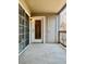 Covered balcony featuring sliding glass doors, a storage closet, and an outdoor light fixture at 9262 E Arbor Cir # H, Englewood, CO 80111