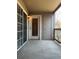View of a covered balcony with sliding glass door and exterior storage closet at 9262 E Arbor Cir # H, Englewood, CO 80111