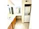 Bathroom featuring a vanity with large mirrors and stacked washer and dryer units at 9262 E Arbor Cir # H, Englewood, CO 80111