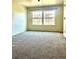 Bright bedroom with neutral carpet, large window, and ample natural light at 9262 E Arbor Cir # H, Englewood, CO 80111