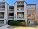 Multi-level condo building with balconies and partial stone facade, surrounded by mature landscaping at 9262 E Arbor Cir # H, Englewood, CO 80111