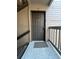 Close-up of a dark front door with a knocker and unit number, creating a welcoming entrance at 9262 E Arbor Cir # H, Englewood, CO 80111