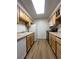 Galley kitchen with wood cabinets and modern appliances, including a dishwasher at 9262 E Arbor Cir # H, Englewood, CO 80111