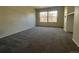 Large living room featuring neutral walls and gray carpeting with a window at 9262 E Arbor Cir # H, Englewood, CO 80111