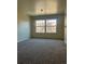 Living room with neutral paint and carpet and a large window for ample natural light at 9262 E Arbor Cir # H, Englewood, CO 80111