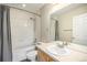 Bathroom shows a tub, shower, toilet, and vanity with a large mirror, offering essential amenities at 755 Roslyn St # 17, Denver, CO 80230