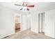 Carpeted bedroom with closet and ceiling fan, flowing into an en-suite bathroom at 755 Roslyn St # 17, Denver, CO 80230