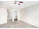 Bedroom features neutral carpet and paint, with access to a closet and an ensuite bathroom at 755 Roslyn St # 17, Denver, CO 80230