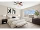 Comfortable bedroom with neutral carpet, ceiling fan, ample light from large window and modern decor at 755 Roslyn St # 17, Denver, CO 80230