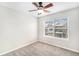 Cozy bedroom has neutral carpet, ceiling fan and a large window overlooking the outdoors at 755 Roslyn St # 17, Denver, CO 80230