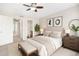 Well-furnished bedroom boasts carpet, a ceiling fan, and neutral tones, creating a restful ambiance at 755 Roslyn St # 17, Denver, CO 80230