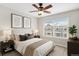 Comfortable bedroom features plush carpet, ceiling fan and an expansive window view at 755 Roslyn St # 17, Denver, CO 80230