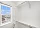 Walk-in closet with adjustable shelving and a window bringing in natural light at 755 Roslyn St # 17, Denver, CO 80230