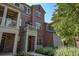 Inviting exterior view of a brick multi-story townhome with well-kept landscaping at 755 Roslyn St # 17, Denver, CO 80230
