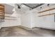 Spacious two car garage with shelving and ample space for storage or a workbench at 755 Roslyn St # 17, Denver, CO 80230