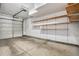 Spacious garage interior featuring open storage shelves and concrete flooring at 755 Roslyn St # 17, Denver, CO 80230