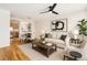 Cozy living room and dining area showcasing a kitchen pass-through, ceiling fan and modern décor at 755 Roslyn St # 17, Denver, CO 80230