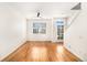 Open-concept living room with hardwood floors, a ceiling fan, and natural light at 755 Roslyn St # 17, Denver, CO 80230