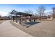 Outdoor shot showing a collection of park benches and tables under shade structures at 755 Roslyn St # 17, Denver, CO 80230