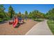 This playground has slides, climbing structures, and a soft mulch ground, surrounded by trees at 755 Roslyn St # 17, Denver, CO 80230